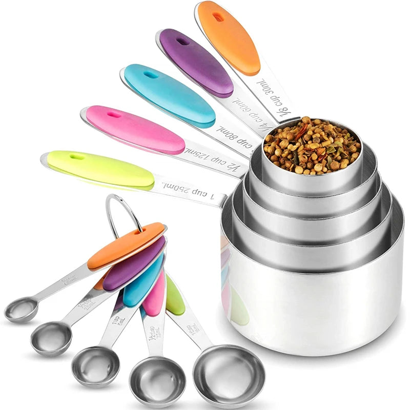 A set of stainless steel measuring cups and spoons in various colors, stacked and displayed on a white background.