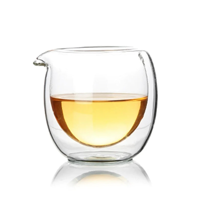 A clear double-wall glass tea pitcher filled with golden-colored liquid.