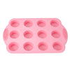 A pink silicone baking set with multiple round molds for cakes and desserts.