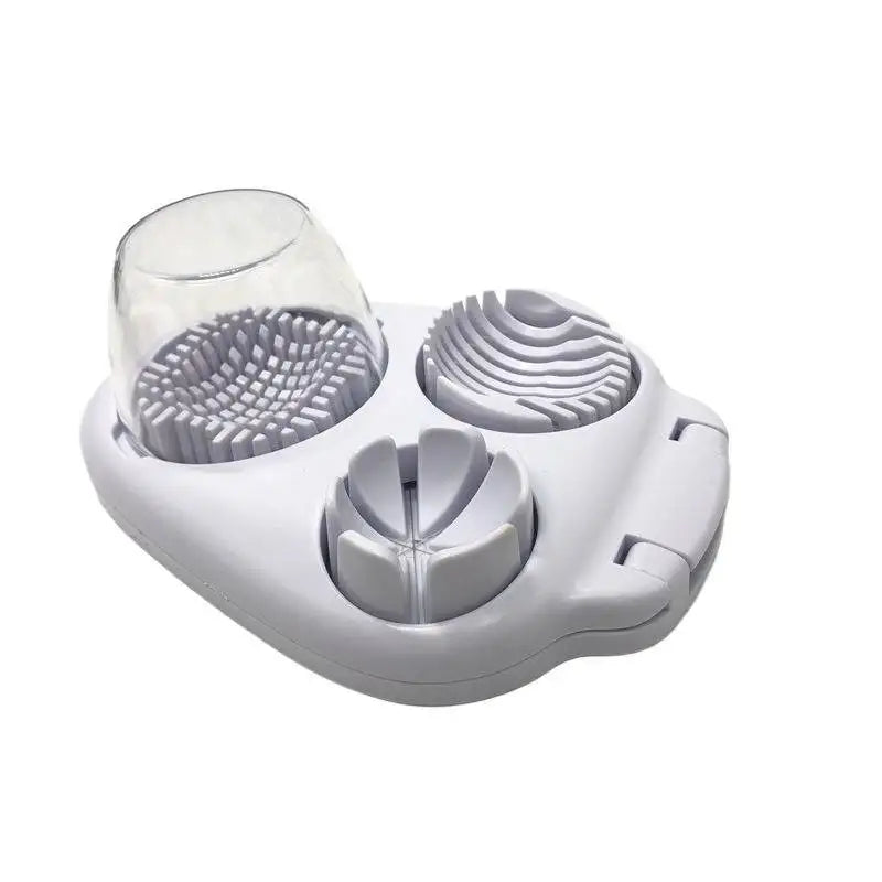 A white multi-function egg slicer and fruit cutter with a clear glass section and various cutting discs.