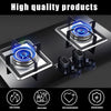 Close-up view of a black gas stove with blue flame burners and various safety features like heat-resistant surfaces and secur
