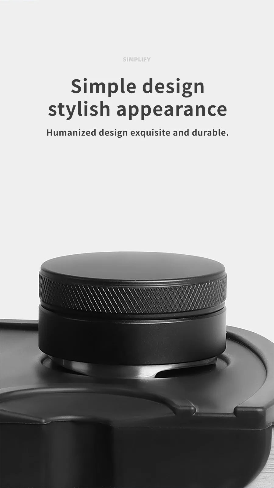 A close-up view of a black precision espresso distribution tool with a textured cap.