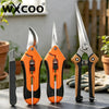 A set of professional stainless steel gardening shears in orange and black are displayed on a dark surface.