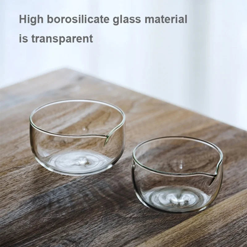 Two clear glass serving bowls resting on a wooden surface.