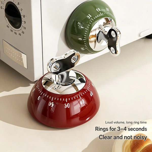 Roter magnetischer Küchentimer mit klarem Glasdeckel und silbernem Ring, neben einem grünen digitalen Timer.
