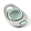 A light green plastic egg slicer and fruit cutter with a gray handle.