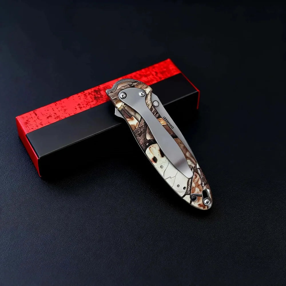 A multi-functional folding utility knife with a mottled brown and beige blade is displayed in a red box.