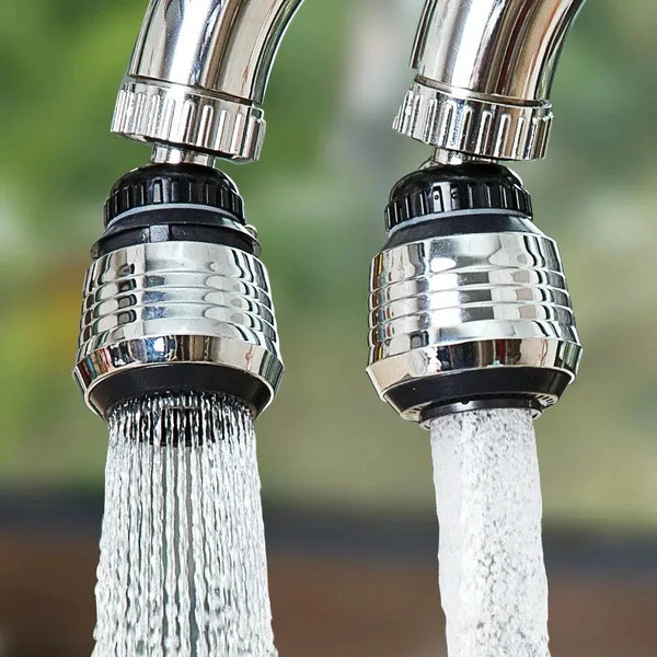 Close-up of a chrome kitchen faucet with a powerful spray of water.