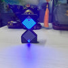 A black LED digital hourglass timer with a glowing blue diamond pattern sits on a white surface.