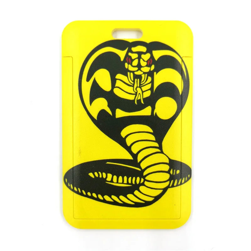 A yellow plastic lanyard featuring a black stylized snake design.