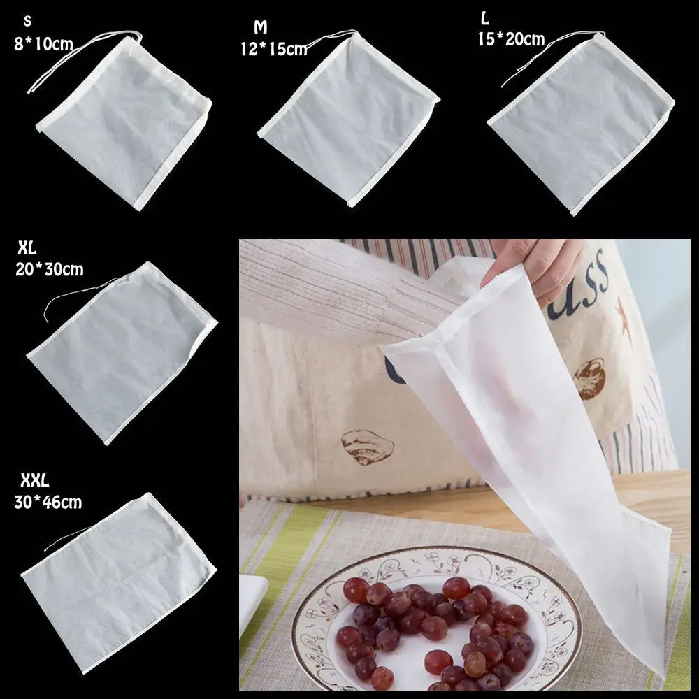 Various sizes of white reusable fine mesh food strainers and a hand holding one over a plate of grapes.