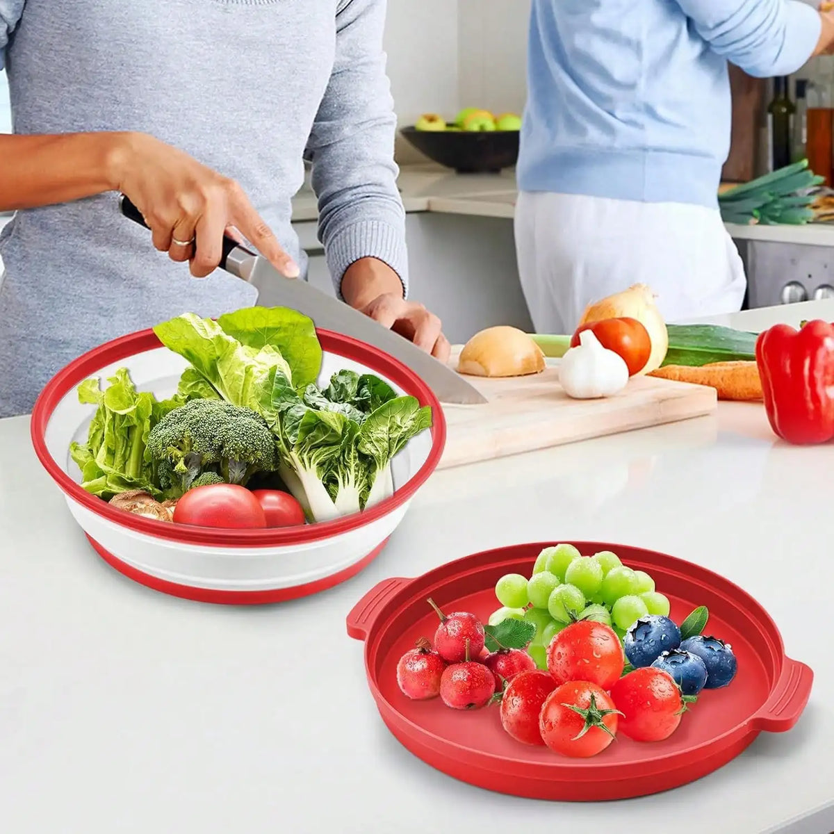 A red silicone splatter guard bowl filled with fresh vegetables is shown on a white countertop.