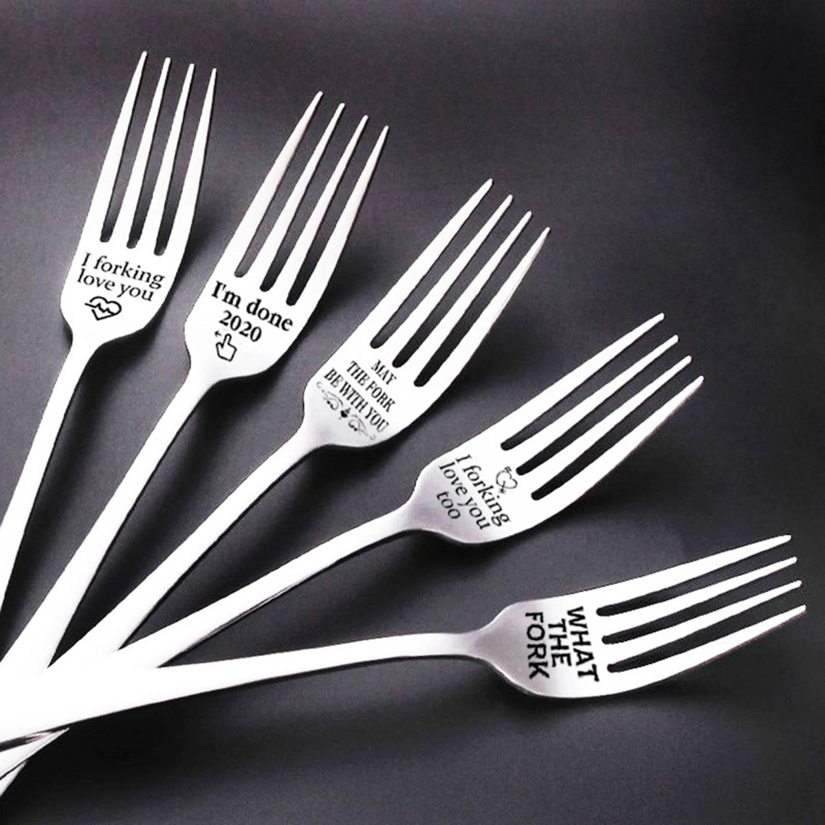 A set of stainless steel serving forks engraved with messages like I forking love you and I'm done 2020