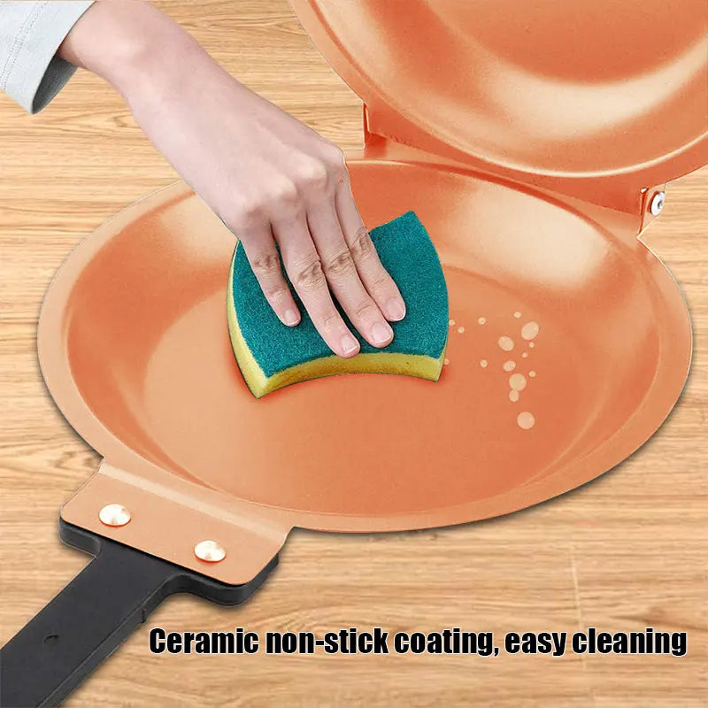 A hand is cleaning a terracotta-colored non-stick frying pan with a green sponge.