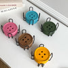 A set of six decorative wooden coasters with iron racks in various colors including teal, pink, olive green, and yellow.