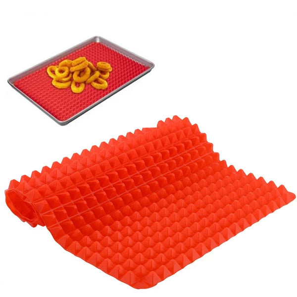 Orange silicone BBQ pizza mat with a yellow food item and an orange baking liner