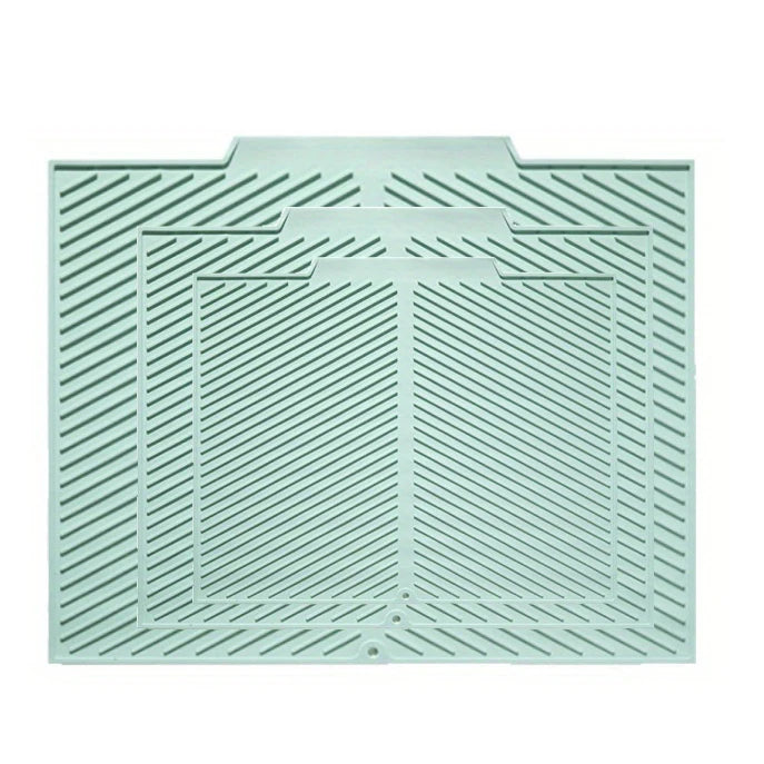 A light mint green silicone collapsible dish drying mat with a textured, ribbed surface.