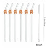 A set of clear glass straws with long stems and a metal brush attached.