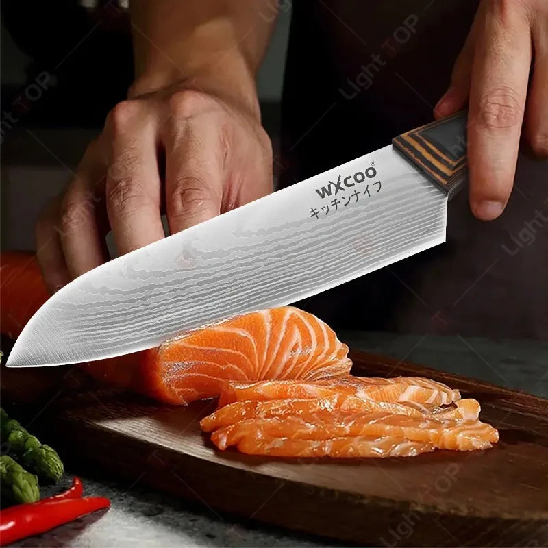 A hand is holding a silver kitchen knife with a wooden handle, slicing fresh orange salmon on a wooden cutting board.