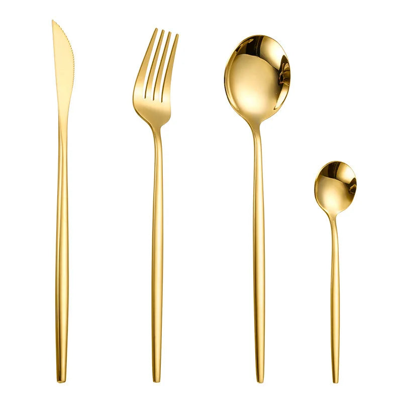 A set of four gold flatware pieces including a knife, fork, spoon, and another utensil.