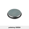 A round, silver-gray polishing disc with a black rim used for knife sharpening.