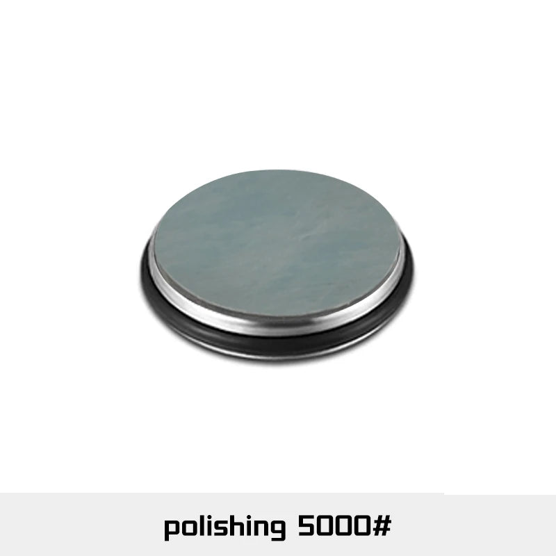 A round, silver-gray polishing disc with a black rim used for knife sharpening.