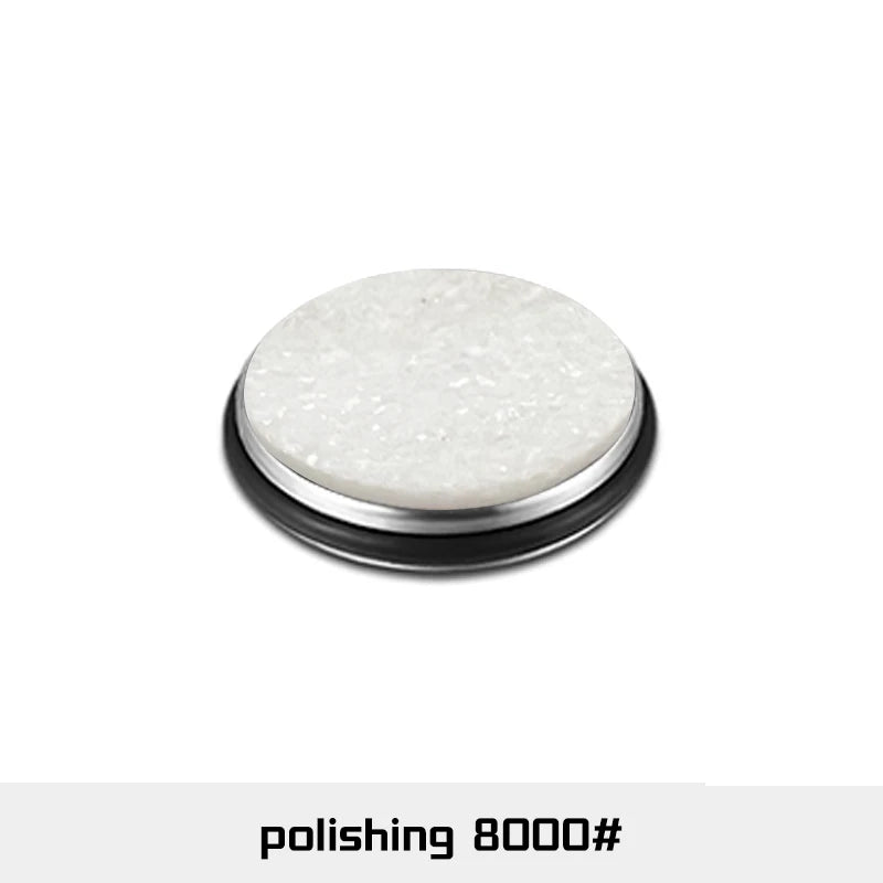 A round, white polishing disc used for sharpening, shown on a black holder.