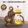 A bronze-colored magnetic suction tea pot set featuring a teapot and a glass cup for making tea.