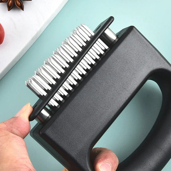 A hand holds a black stainless steel meat tenderizer with 48 needles against a light blue background.
