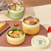 A set of three yellow and green portable stackable thermal lunch boxes filled with various foods like rice, corn, and vegetab