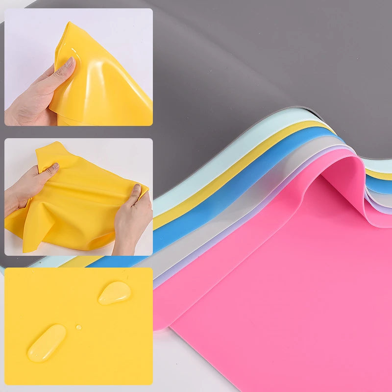 Yellow silicone craft mat being folded and rolled into colorful sheets for jewelry or baking