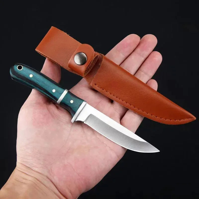 A hand holds a heavy-duty utility cleaver knife with a wooden handle, showing the blade and leather sheath.