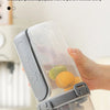 A hand holds a clear double-layer container for overnight oats with a gray leakproof lid.