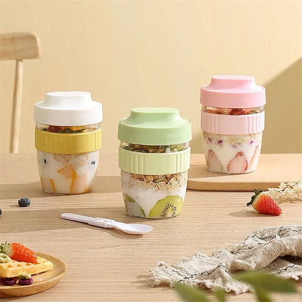 Three clear glass food containers with pink and green lids filled with various ingredients like fruit and herbs