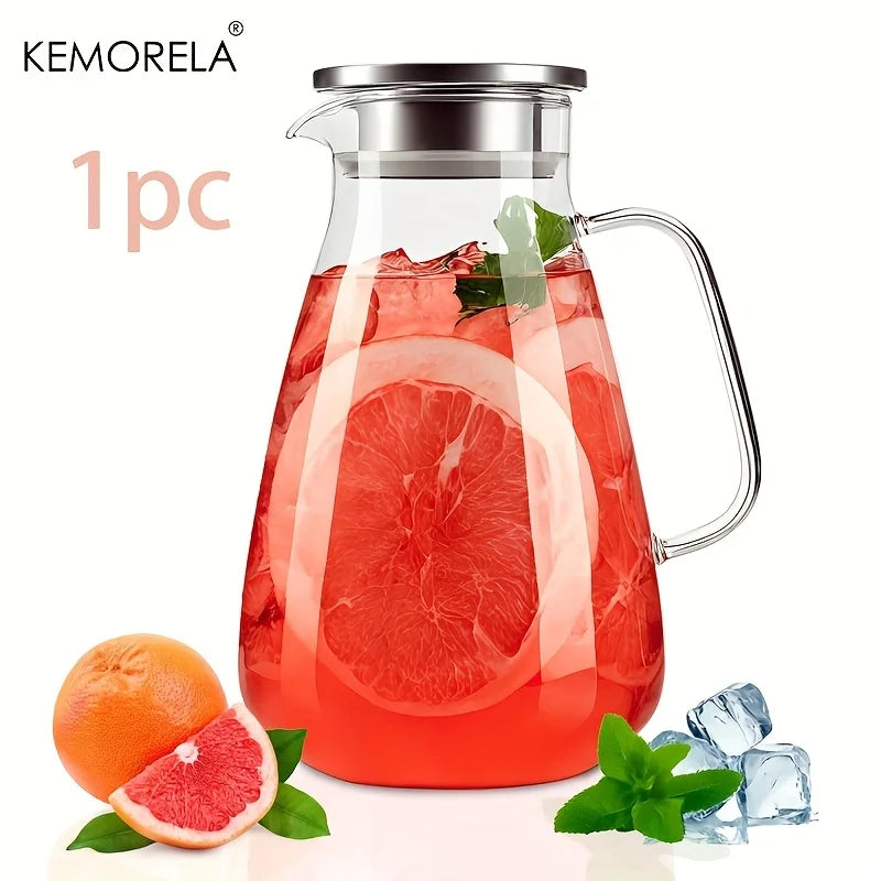 A clear glass pitcher filled with red fruit juice, featuring a metal lid and handle.