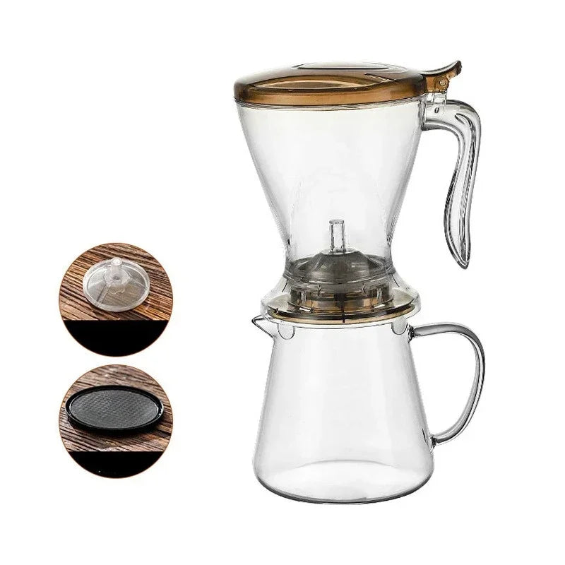A clear glass pour over coffee dripper with a wooden handle and a separate filter basket.