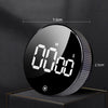 A black magnetic kitchen timer with a digital display showing 00:00, featuring a textured silver ring.