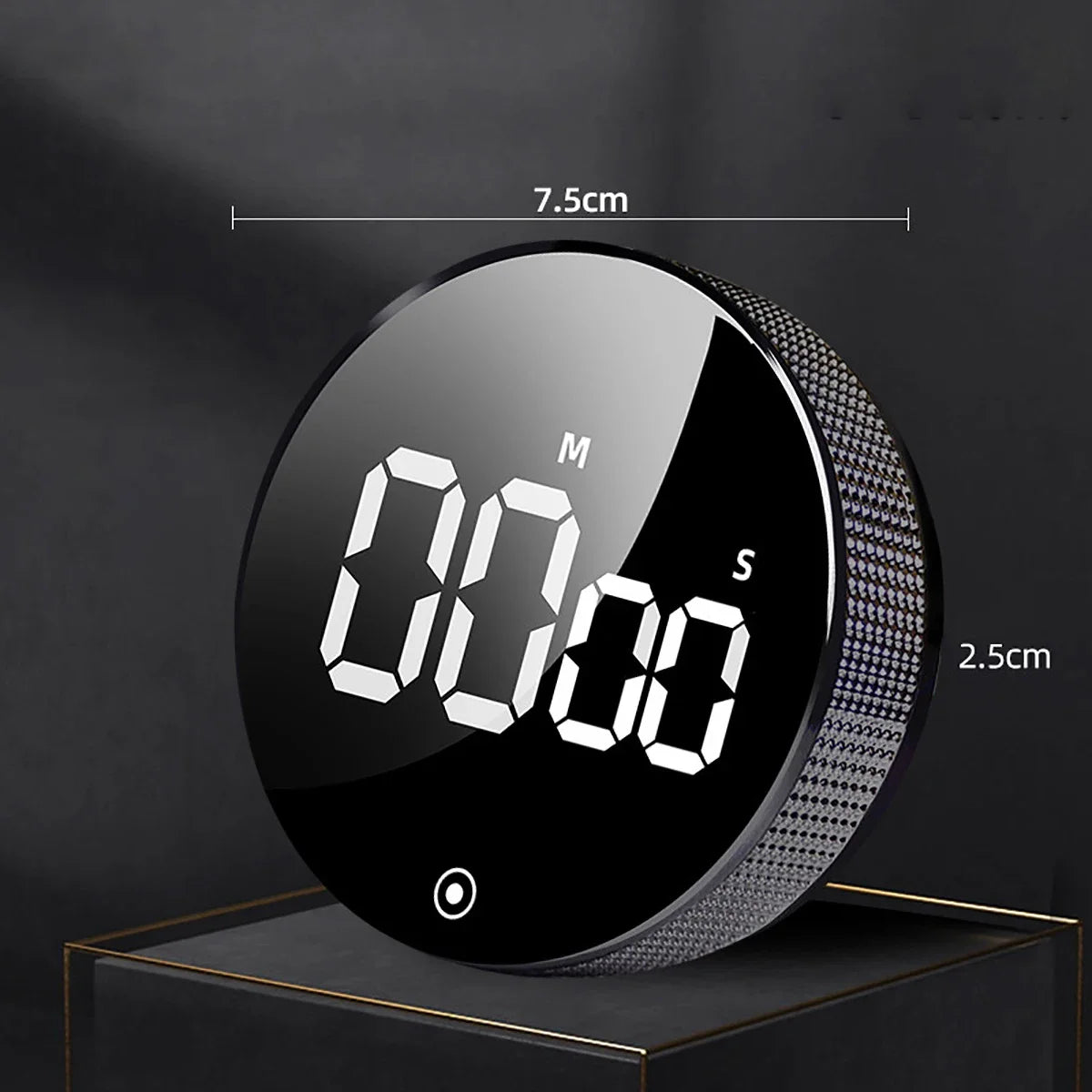 A black magnetic kitchen timer with a digital display showing 00:00, featuring a textured silver ring.