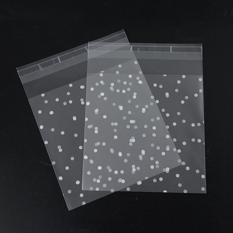 Transparent candy cookie bags with silver dots, shown in a diagonal arrangement.