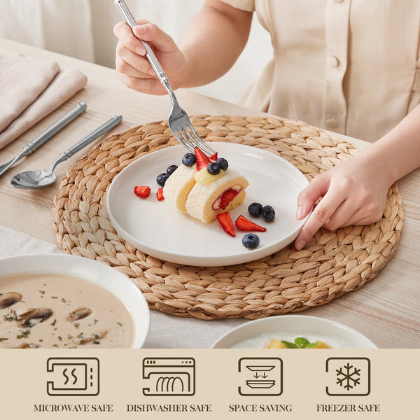 A person is serving food onto a white plate with silverware, next to various kitchen appliances and dinnerware.