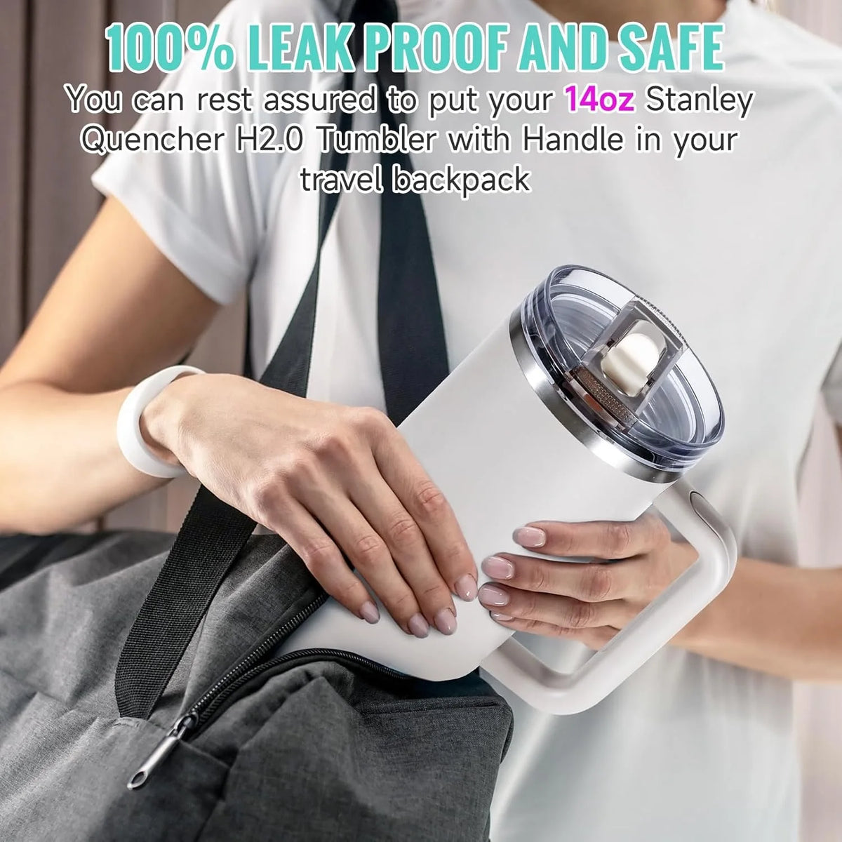 A person holds a white tumbler with a clear lid in a gray backpack.