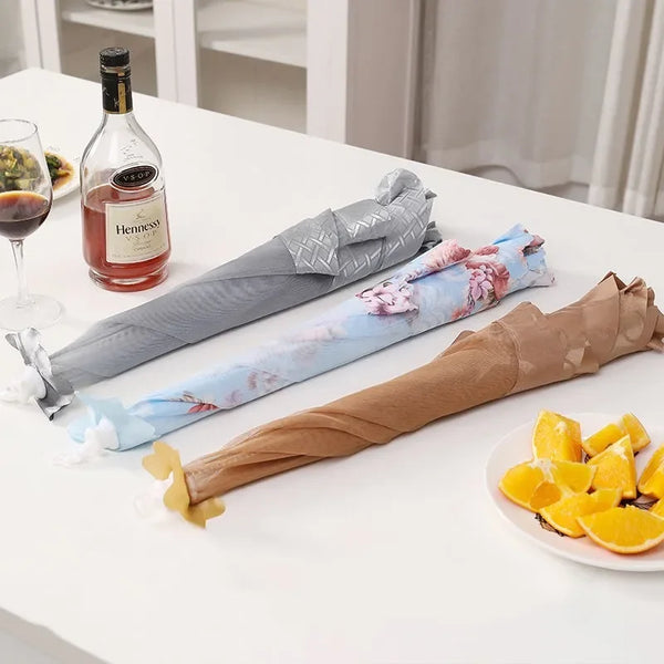 A roll of foldable mesh food covers in various colors and patterns next to a bottle of Hennessy.