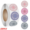 Roll of pink thank you adhesive stickers with various floral designs