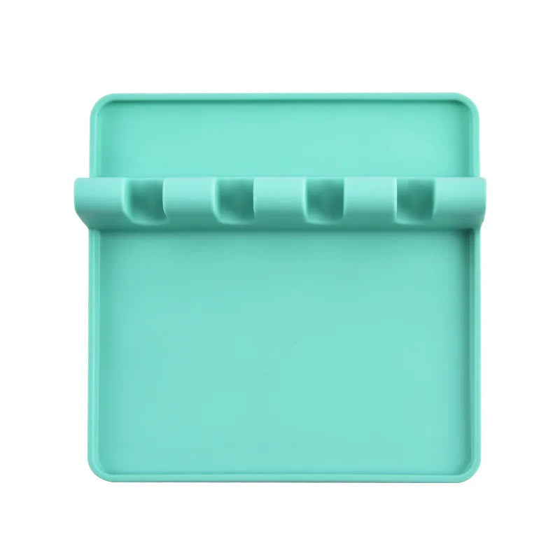 A teal silicone utensil drying rack organizer with a slotted tray for drying kitchen utensils.