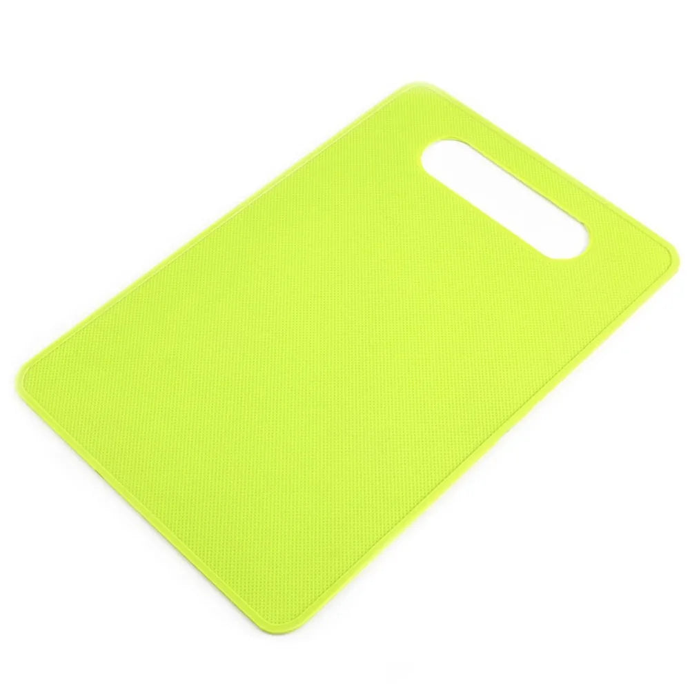 A bright lime green plastic cutting board with a handle, shown from above.
