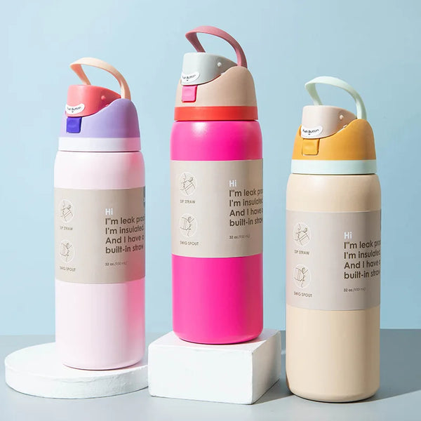 Three pink and beige insulated stainless steel sports tumblers with silicone lids displayed on a light blue background.