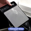 A hand is pouring water onto a black digital kitchen scale with a waterproof design.