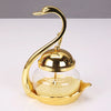 A gold-colored elegant condiment storage jar set featuring a glass dome and a golden spoon.