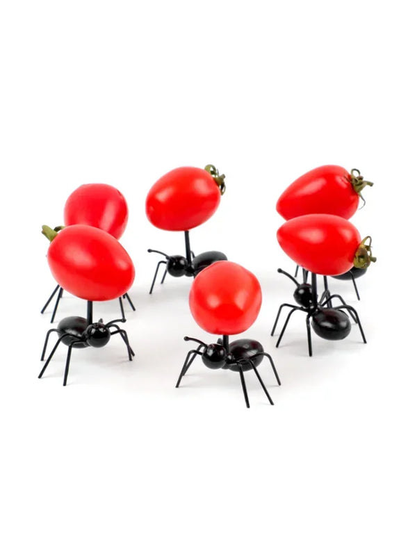 A set of reusable animal appetizer forks featuring bright red, oval-shaped food items mounted on black spider-like holders.