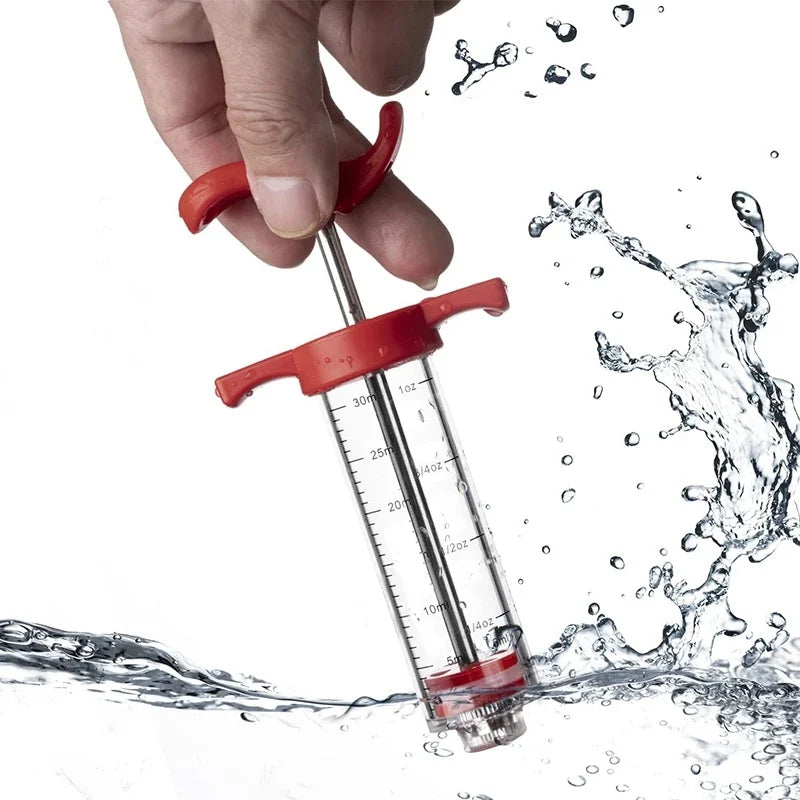 A hand is using a red multi-function meat and poultry injector kit to dispense liquid into water.